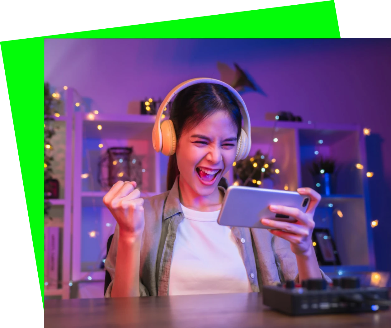 Woman gaming on phone with headphones